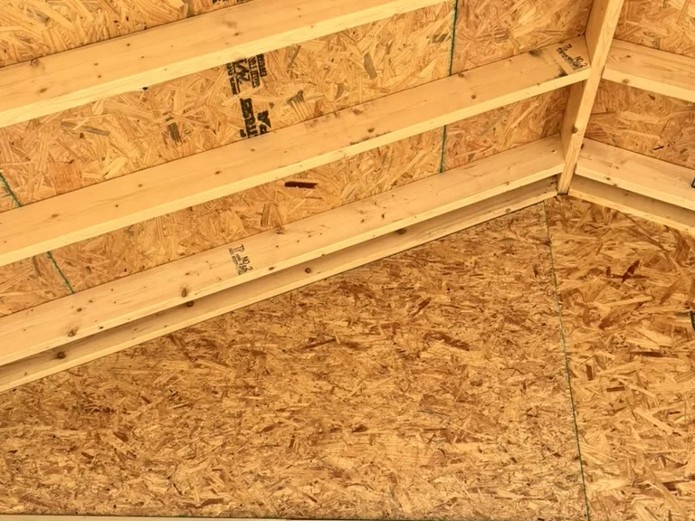 New rafters and roof decking seen from inside the rebuilt room