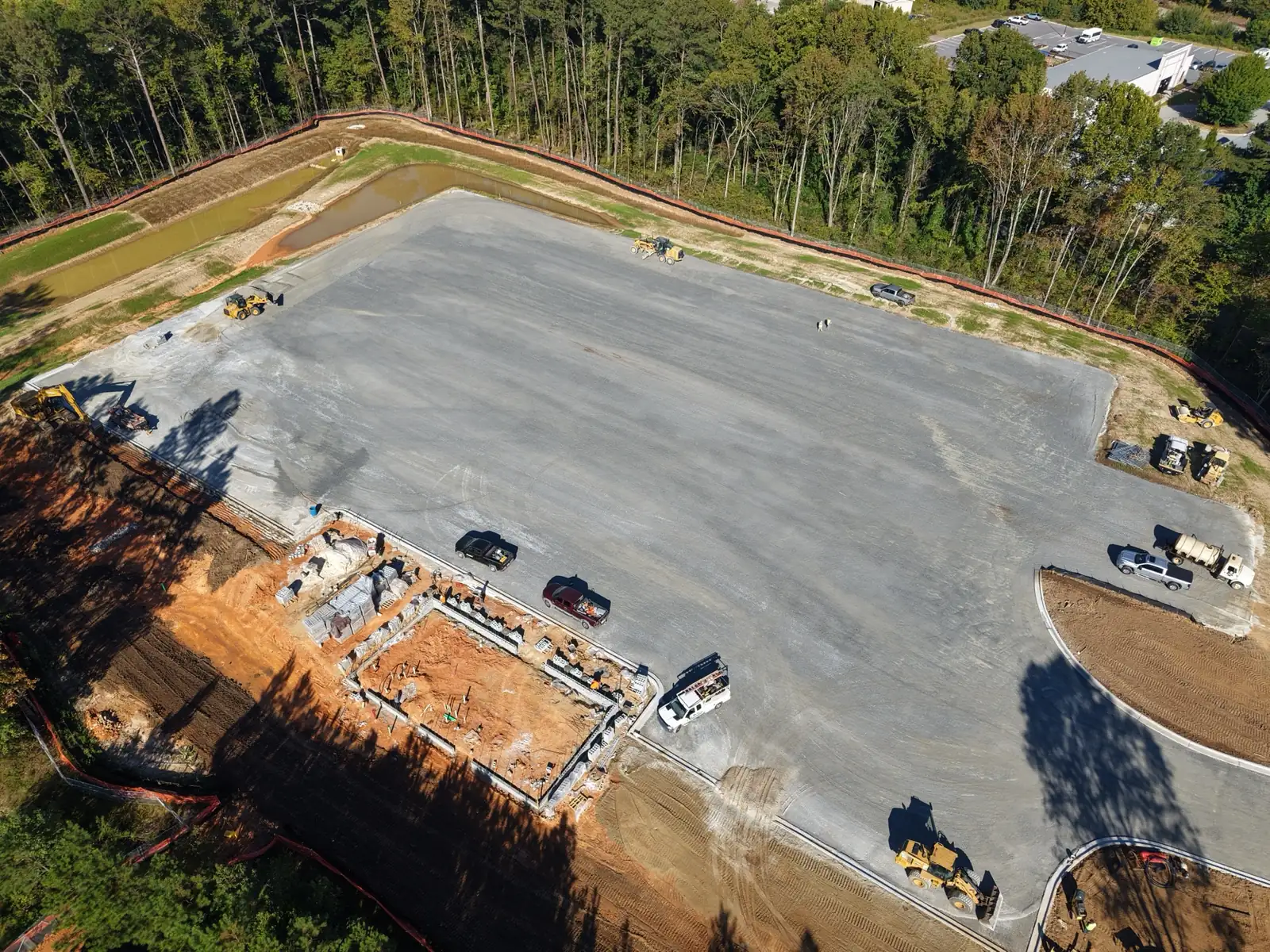 Drone view of building foundation work beside the stone-based CDL training pad at TCSG-411 in Dallas, Georgia