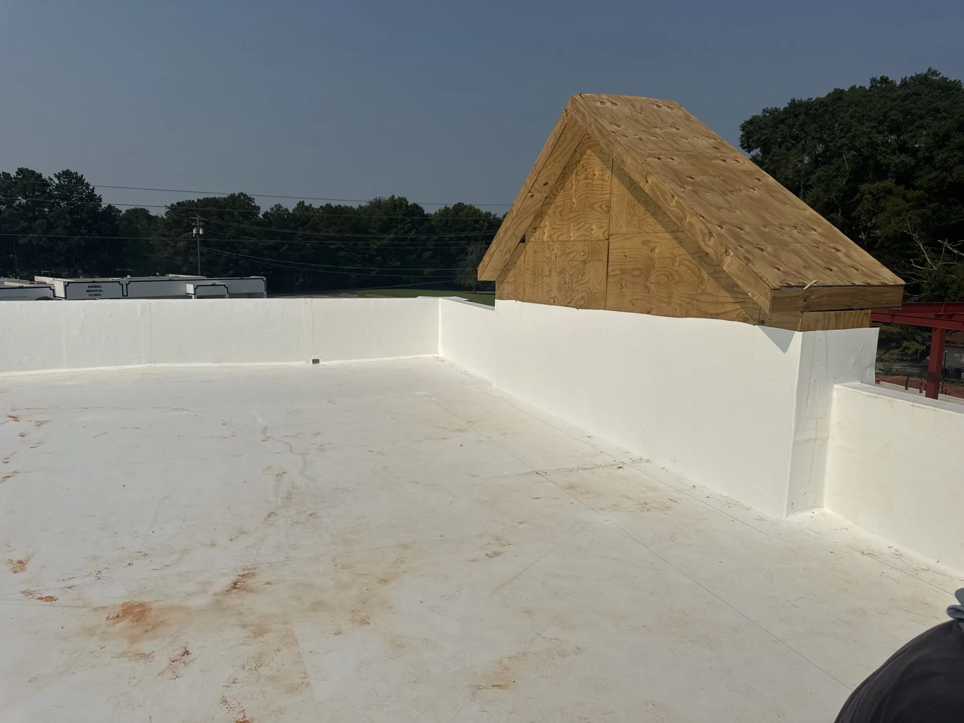 Completed white TPO roof with parapet wall flashing by Integrity CRR